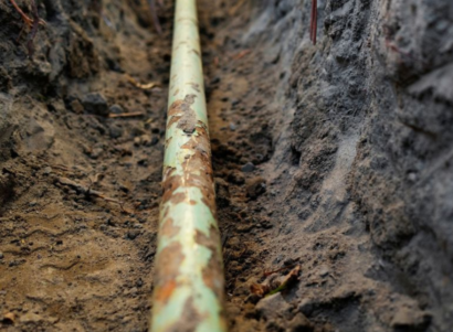 Exposed gas pipeline in soil