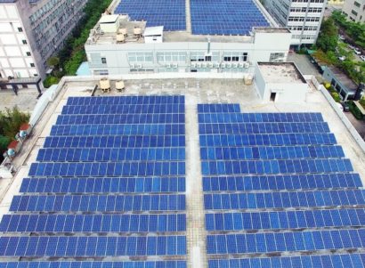 Solar panels across a white rooftop during the day