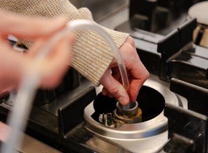 Image of a researchers collecting unburned natural gas from a kitchen stove.