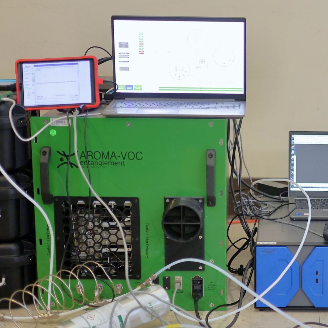 Image of scientific air quality analyzers hooked up to computers.